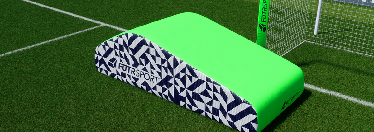 Green PENTA on a marked soccer field beside the goal